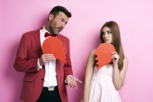 Pareja triste con corazones rotos representando los destructores del cariño en el matrimonio